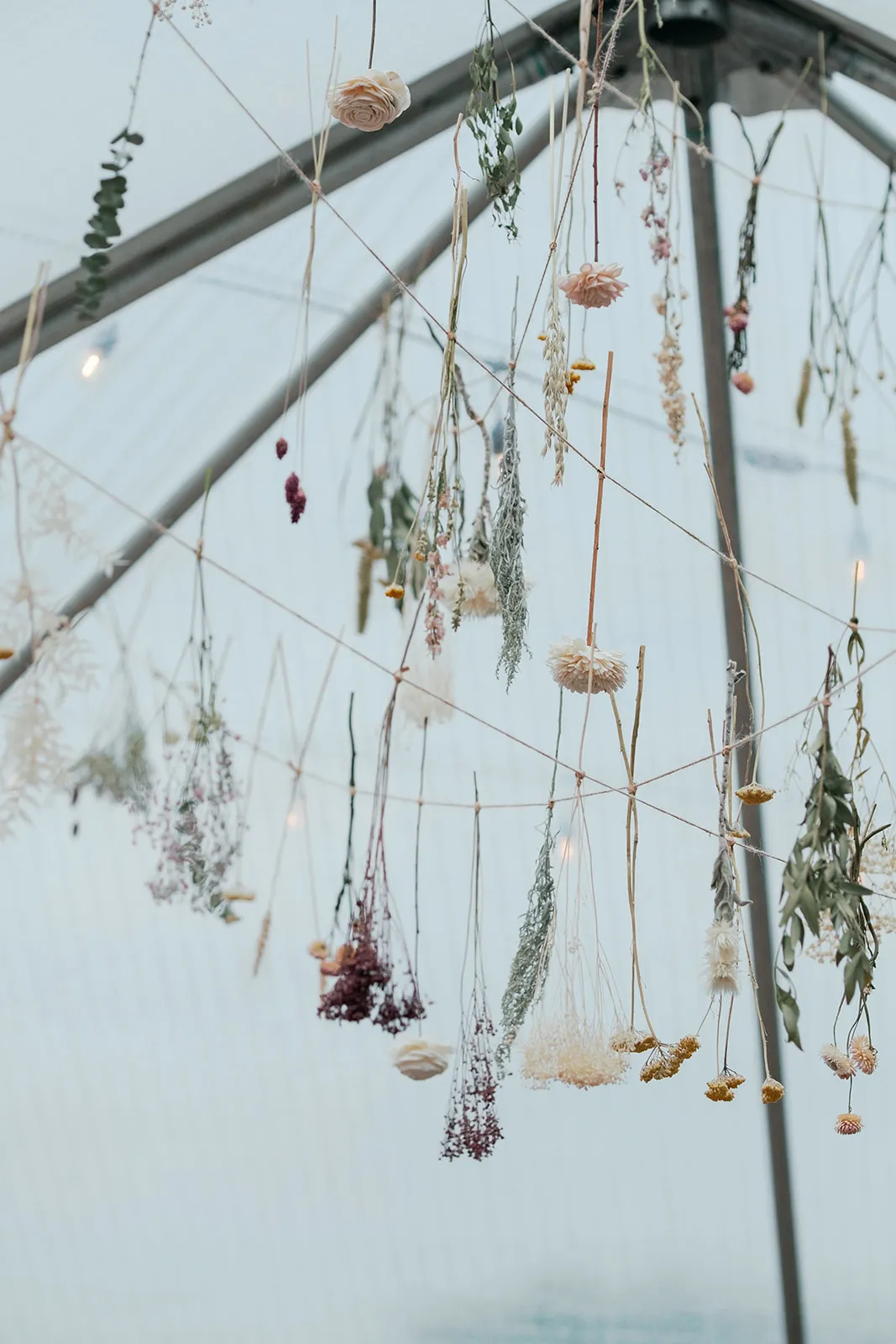 Hanging dried floral installation at a wedding designed by Blush & Bash Event Co.