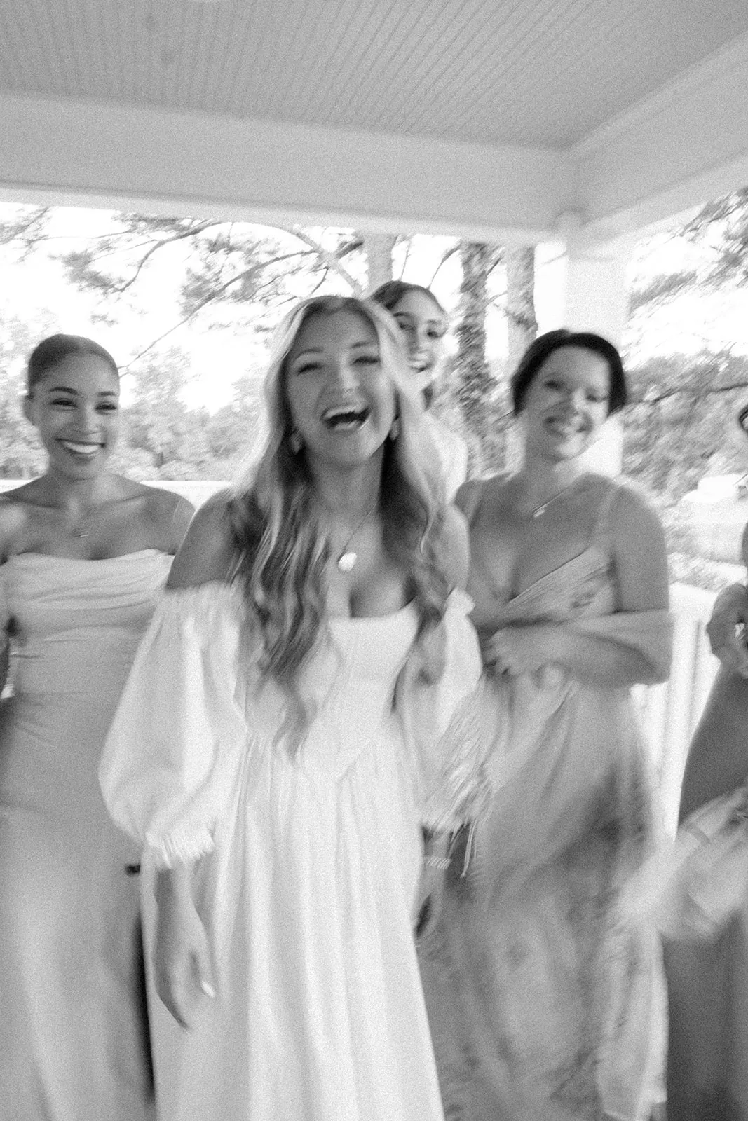 Bride laughing with bridesmaids — candid wedding moment by Blush & Bash Event Co.